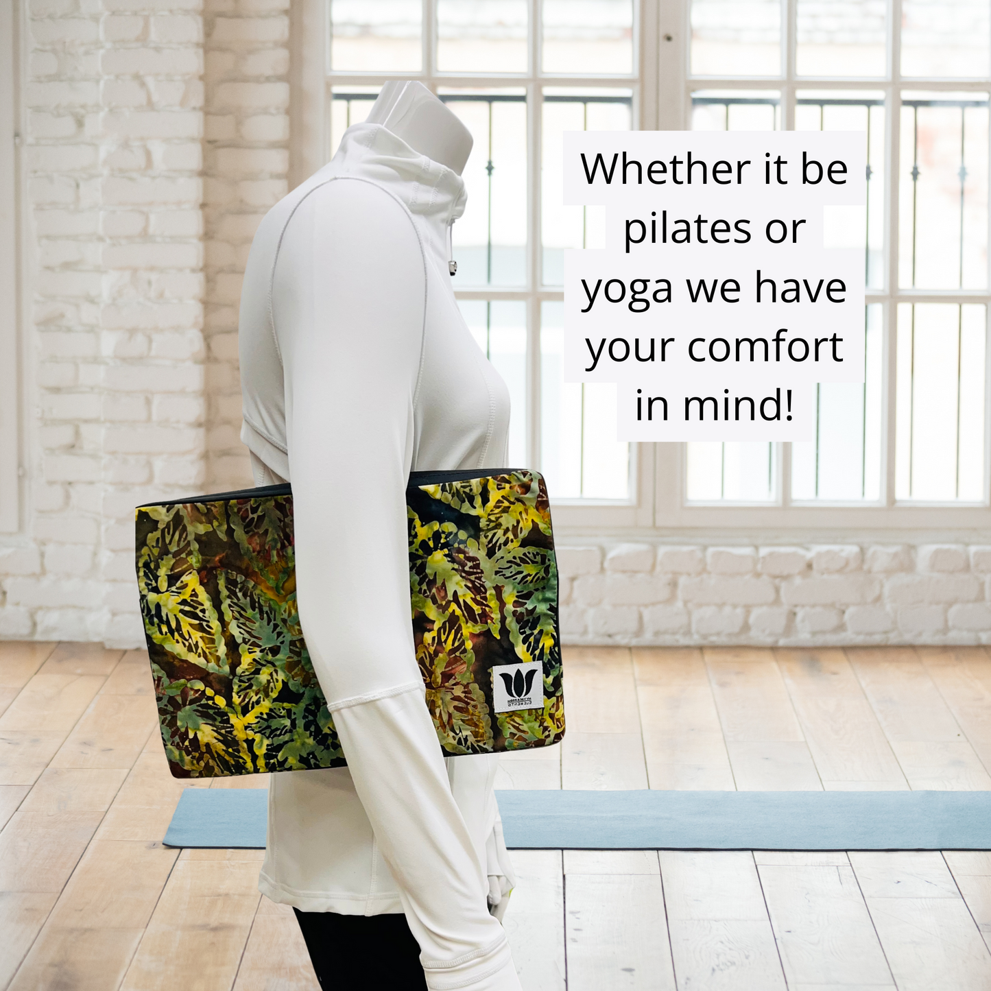 Person holding a colorful yoga prop with text about pilates and yoga comfort.