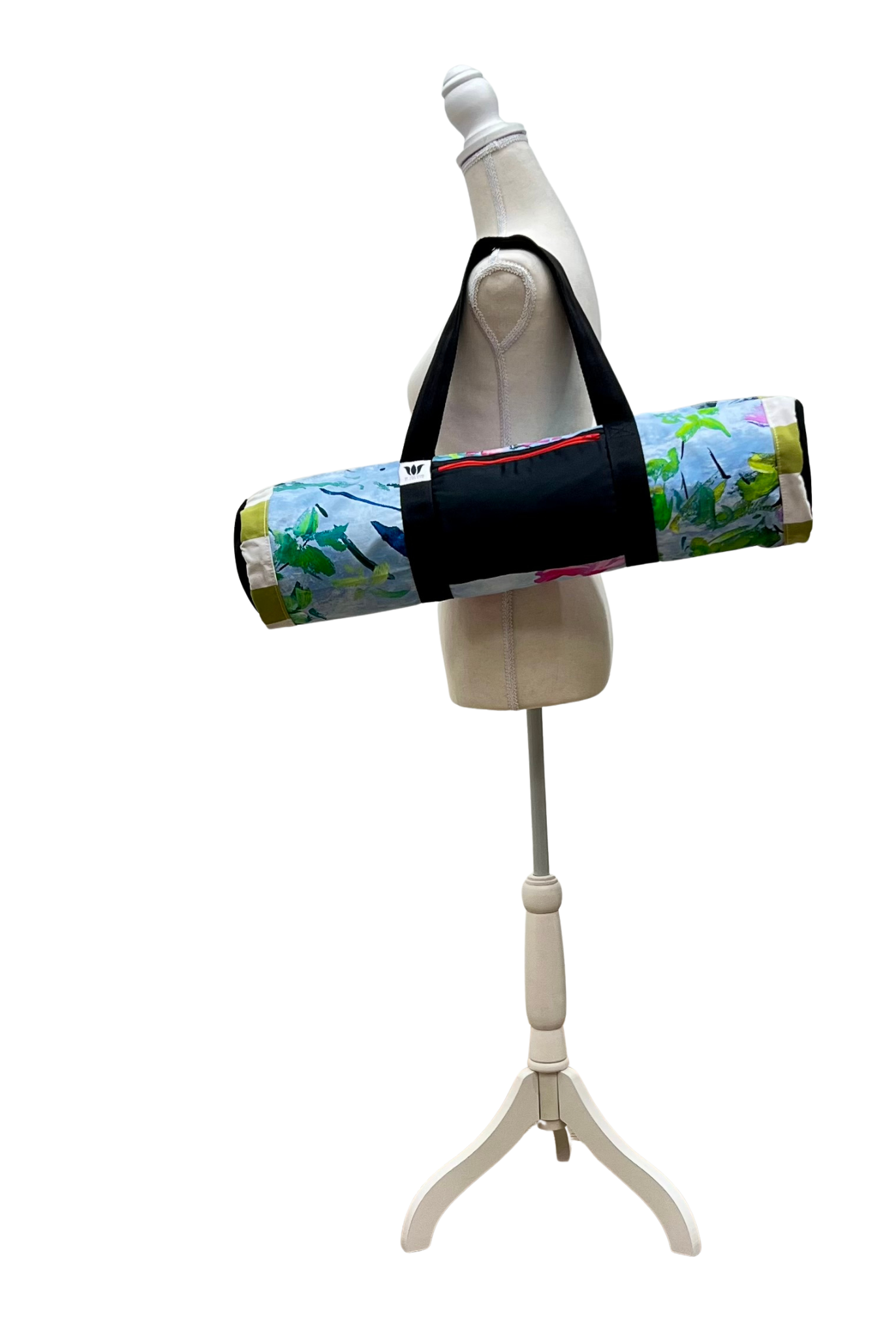 Mannequin with a blue flora yoga bag and black strap on a white background