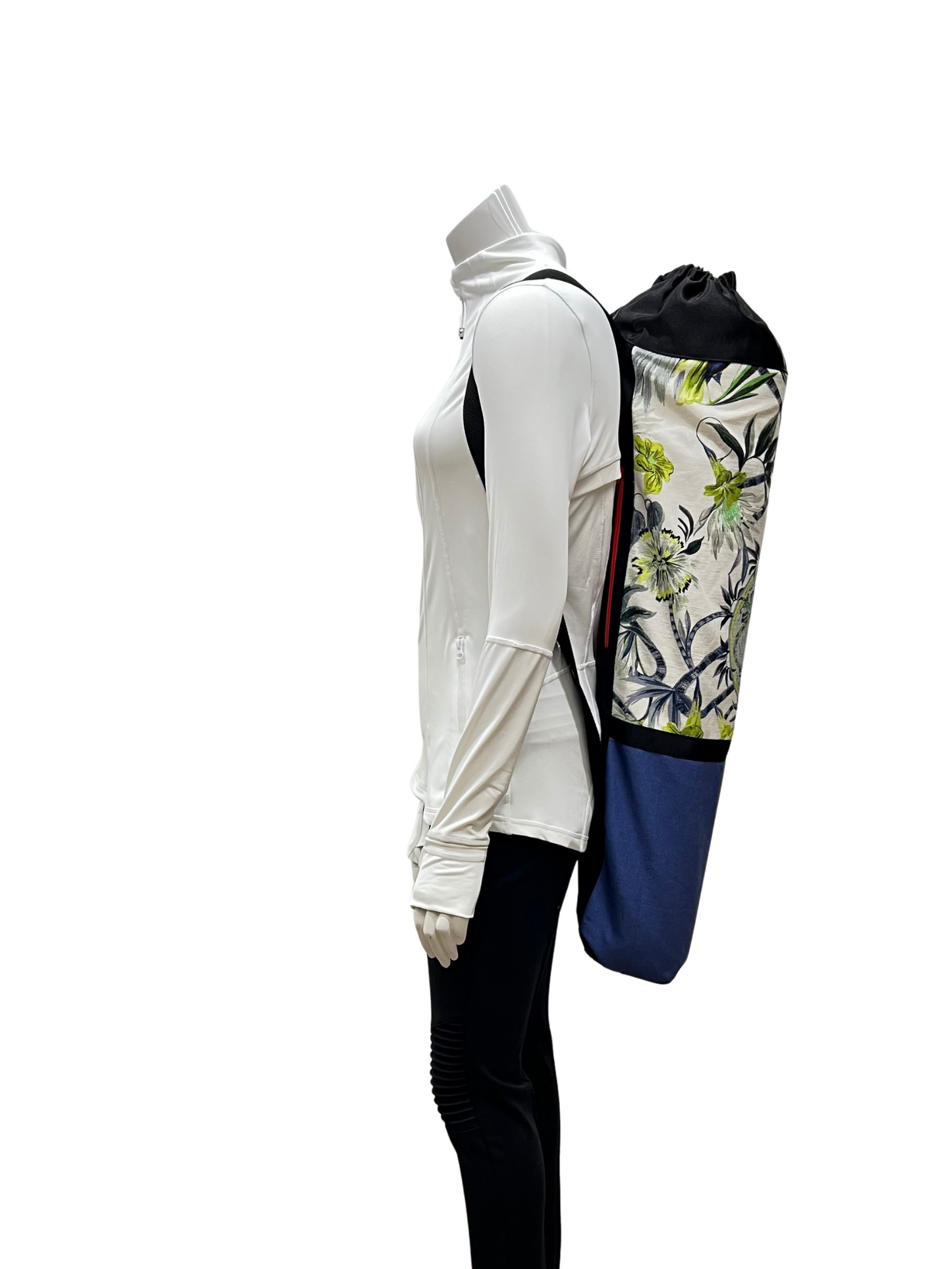 Mannequin wearing a white outfit with a floral-patterned backpack on a white background