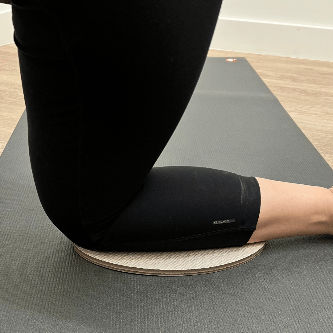 Oval workout / yoga pad, to cushion the body , textured surface, grey in colour