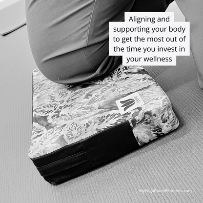 Person using a yoga block on a mat with text about aligning and supporting your body for wellness.