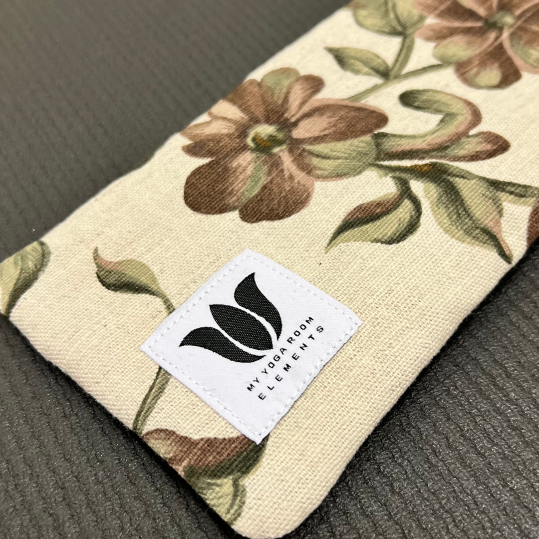 Floral-patterned pouch with a brand label on a textured surface