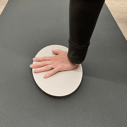 Oval workout / yoga pad, to cushion the body , textured surface, grey in colour