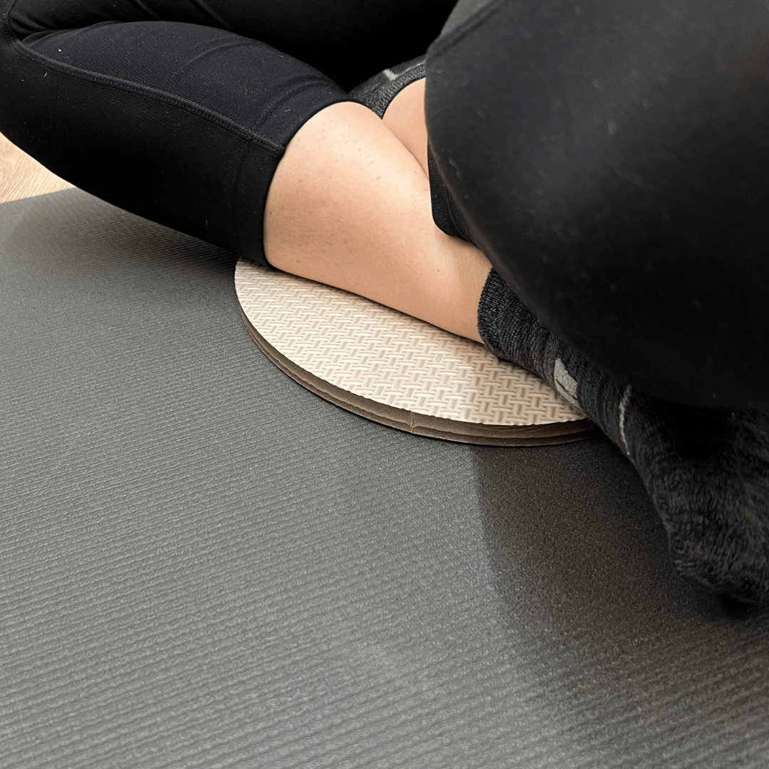 Oval workout / yoga pad, to cushion the body , textured surface, grey in colour