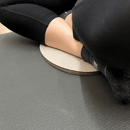 Oval workout / yoga pad, to cushion the body , textured surface, grey in colour