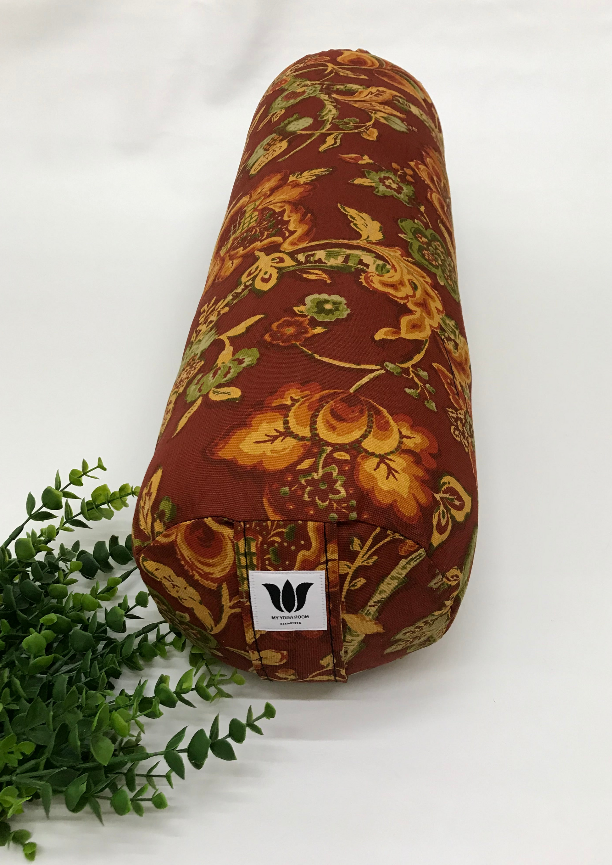 Round yoga bolster in cotton canvas burnt orange floral print fabric. Allergy conscious fill with removeable cover. Made in Canada by My Yoga Room Elements