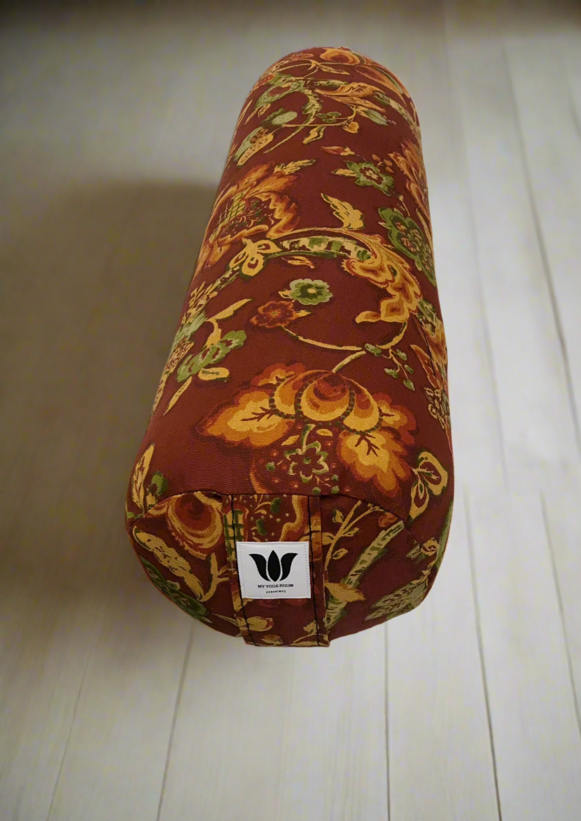 Round yoga bolster in cotton canvas burnt orange floral print fabric. Allergy conscious fill with removeable cover. Made in Canada by My Yoga Room Elements
