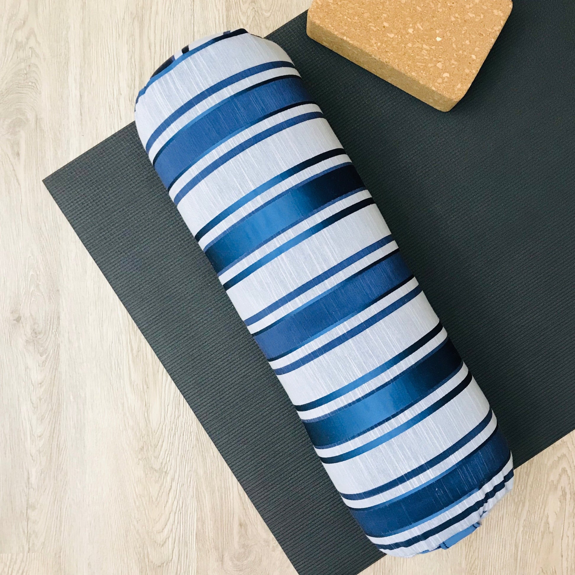 Round yoga bolster in blue and grey strip print fabric. Allergy conscious fill with removeable cover. Made in Canada by My Yoga Room Elements
