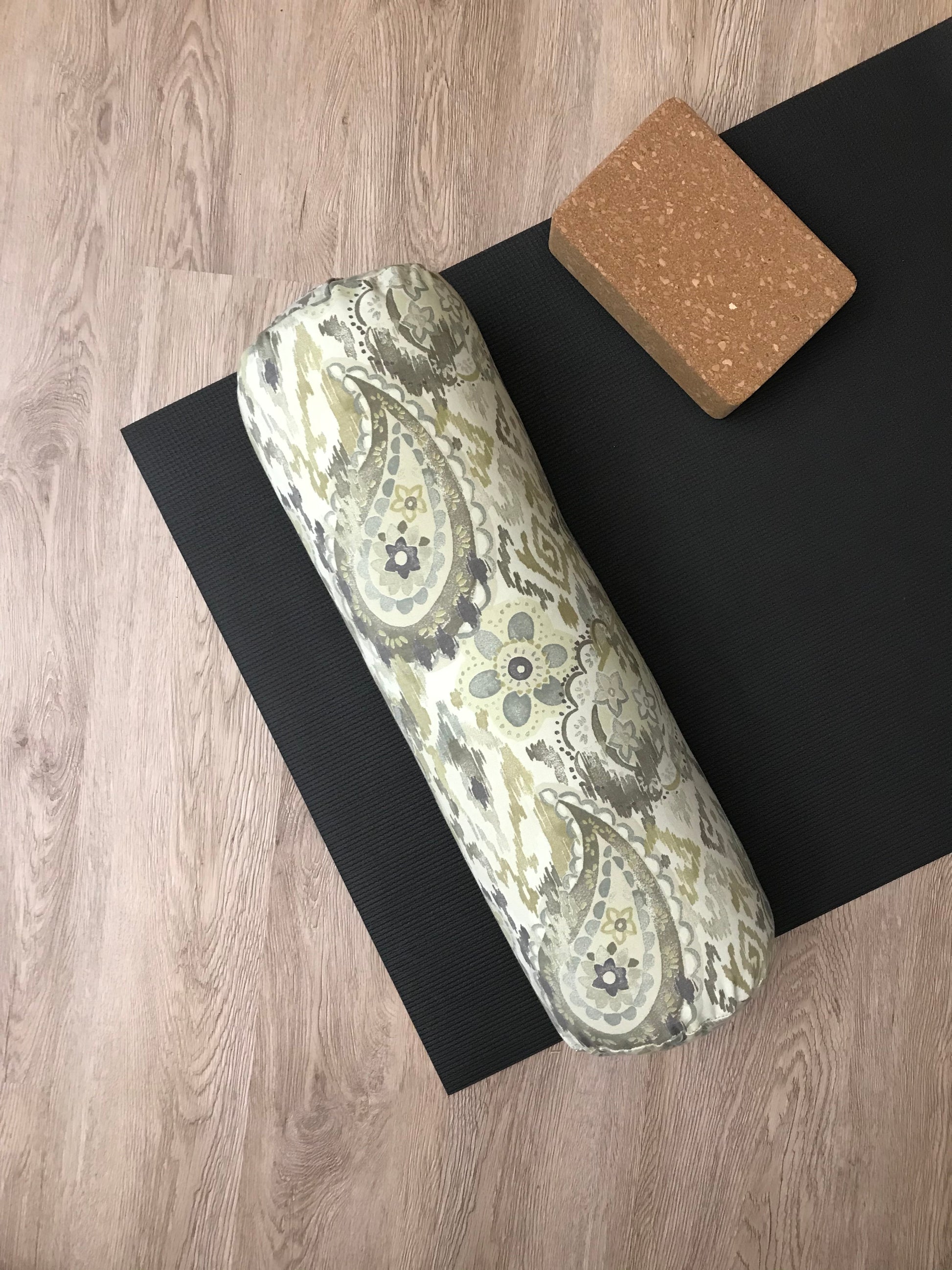 Round yoga bolster in cotton canvas fabric, paisley graphic in sage and beige fabric. Allergy conscious fill with removeable cover. Made in Canada by My Yoga Room Elements