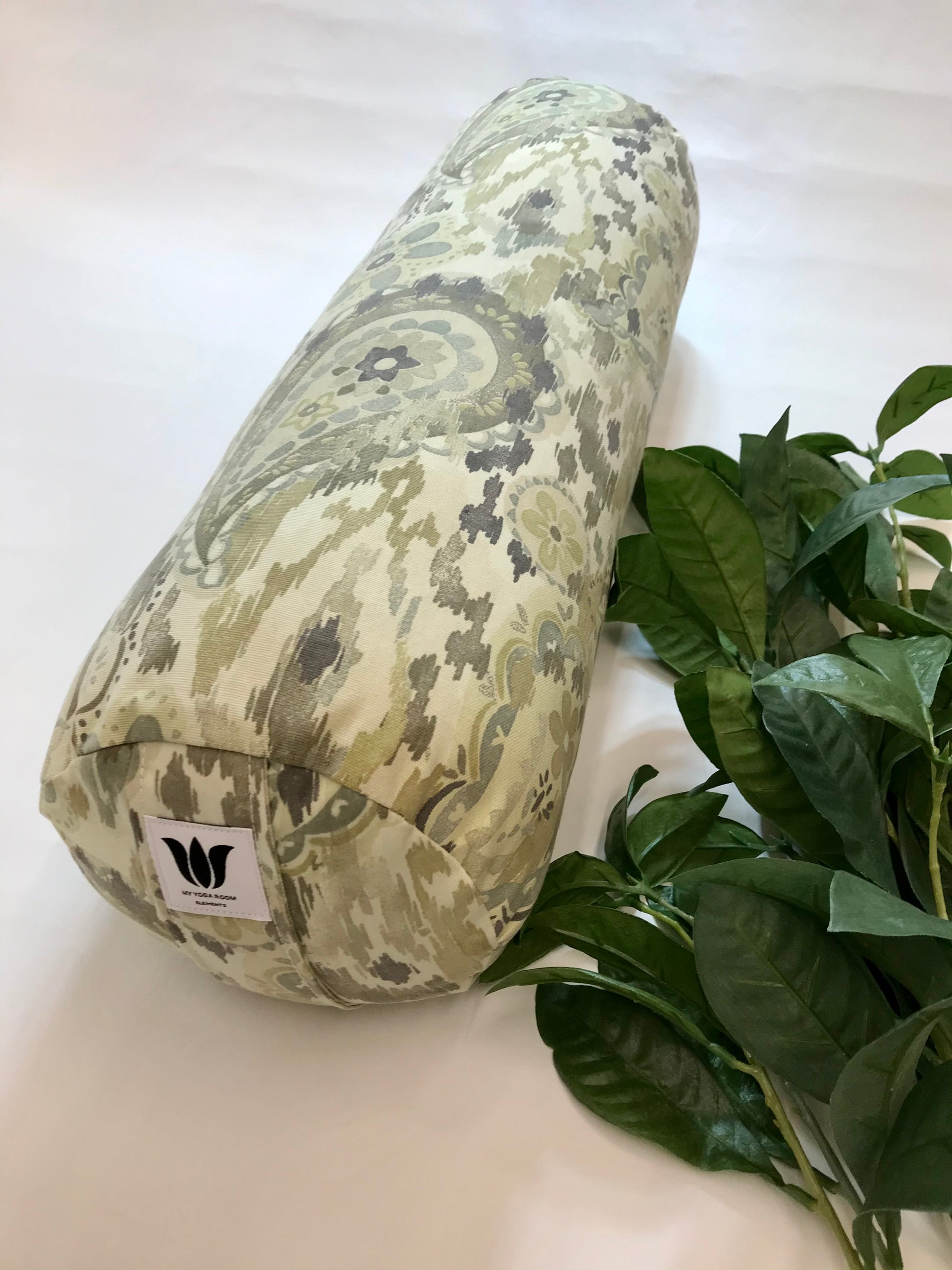 Round yoga bolster in cotton canvas fabric, paisley graphic in sage and beige fabric. Allergy conscious fill with removeable cover. Made in Canada by My Yoga Room Elements