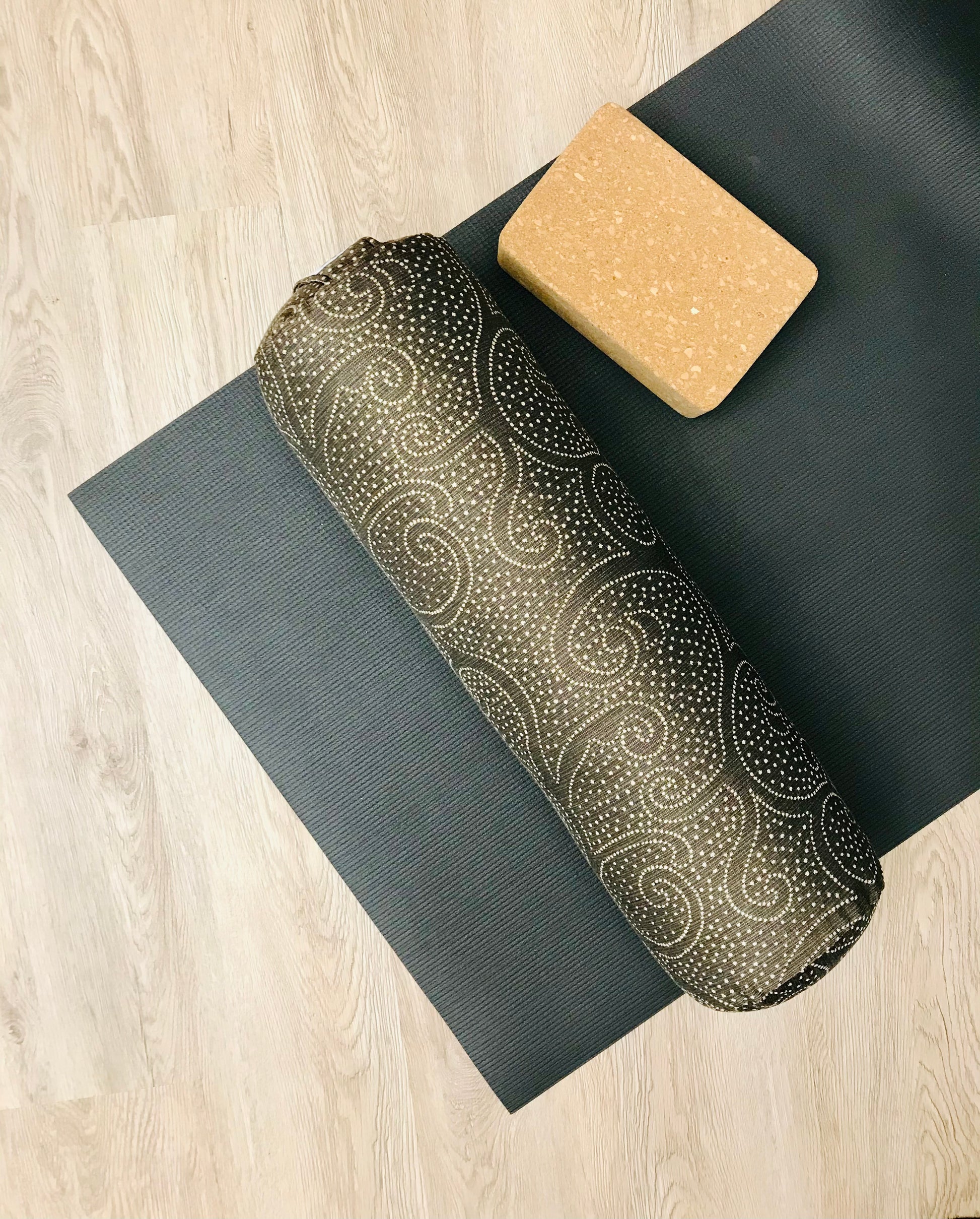 Round yoga bolster in brown durable swirl print fabric . Allergy conscious fill with removeable cover. Made in Canada by My Yoga Room Elements