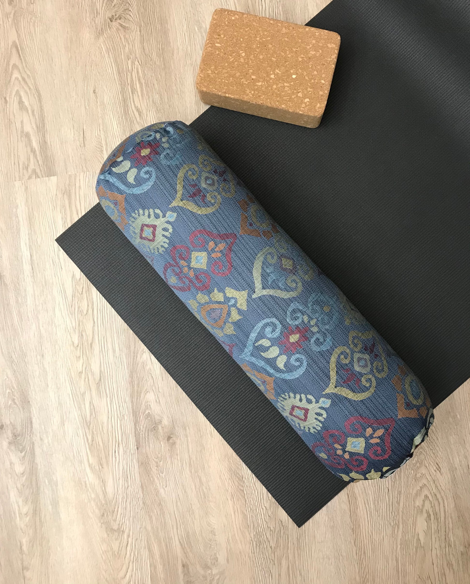Round yoga bolster in blue and smoky rainbow colour print fabric. Allergy conscious fill with removeable cover. Made in Canada by My Yoga Room Elements