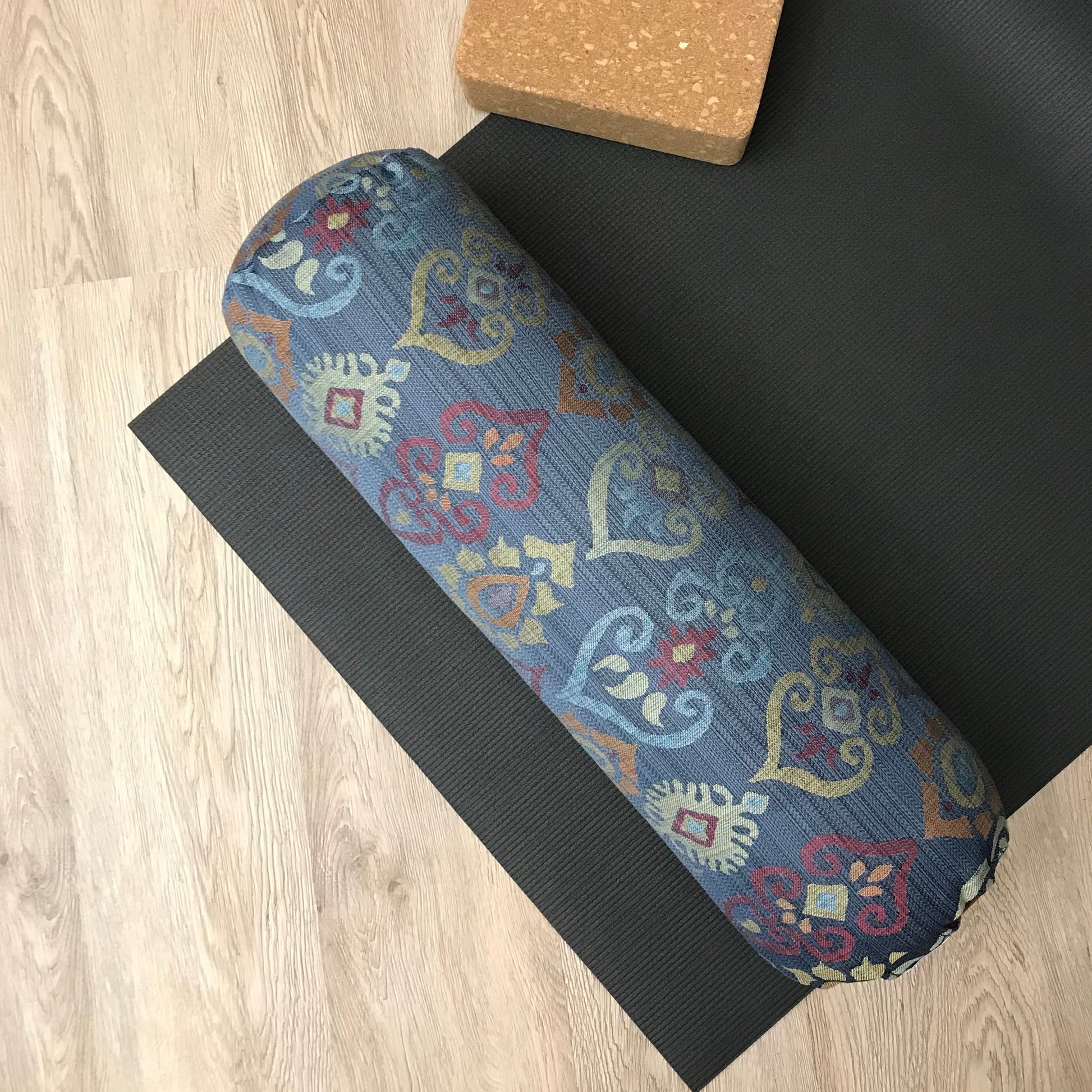 Round yoga bolster in blue and smoky rainbow colour print fabric. Allergy conscious fill with removeable cover. Made in Canada by My Yoga Room Elements