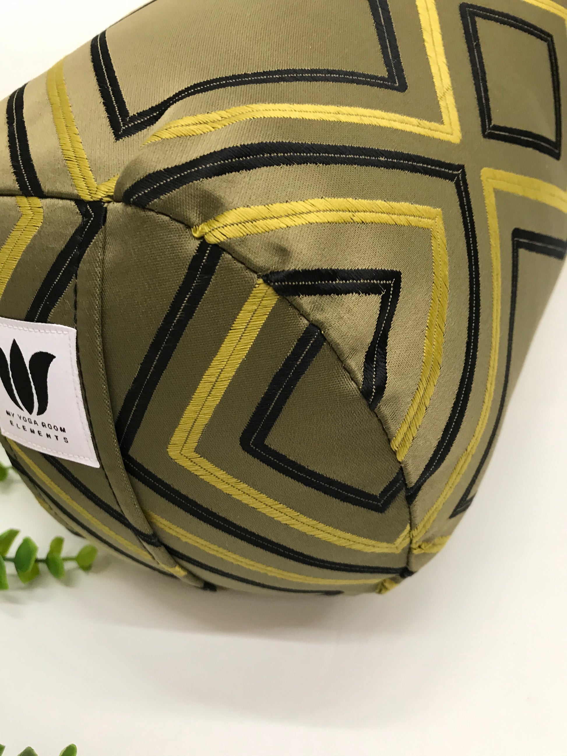 Round yoga bolster in raised embroidered modern diamond print in sage green blue and yellow print fabric. Allergy conscious fill with removeable cover. Made in Canada by My Yoga Room Elements