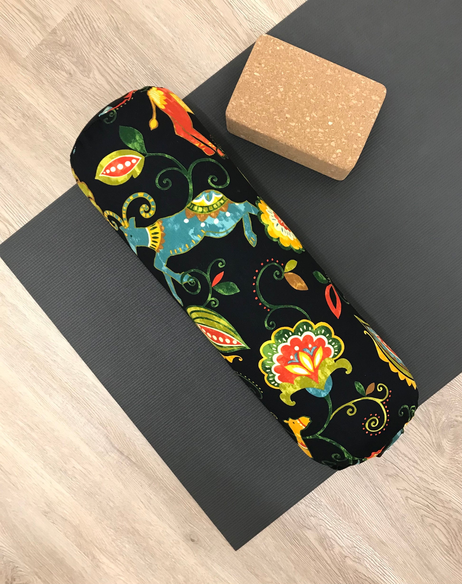 Round yoga bolster in durable cotton canvas, in black and bright colour novelty print fabric. Allergy conscious fill with removeable cover. Made in Canada by My Yoga Room Elements