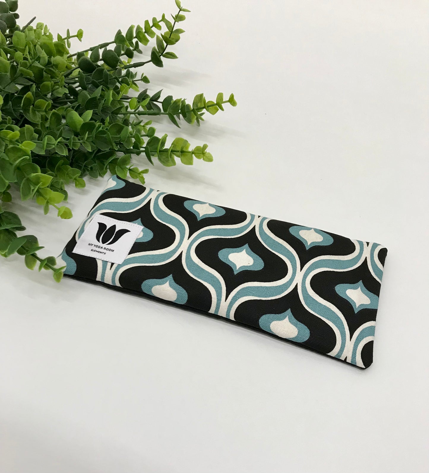 Yoga eye pillow, unscented, therapeutically weighted to soothe eye strain and stress or enhance your savasana. Handcrafted in Canada by My Yoga Room Elements. Black and turquoise mcm print and bamboo fabric.