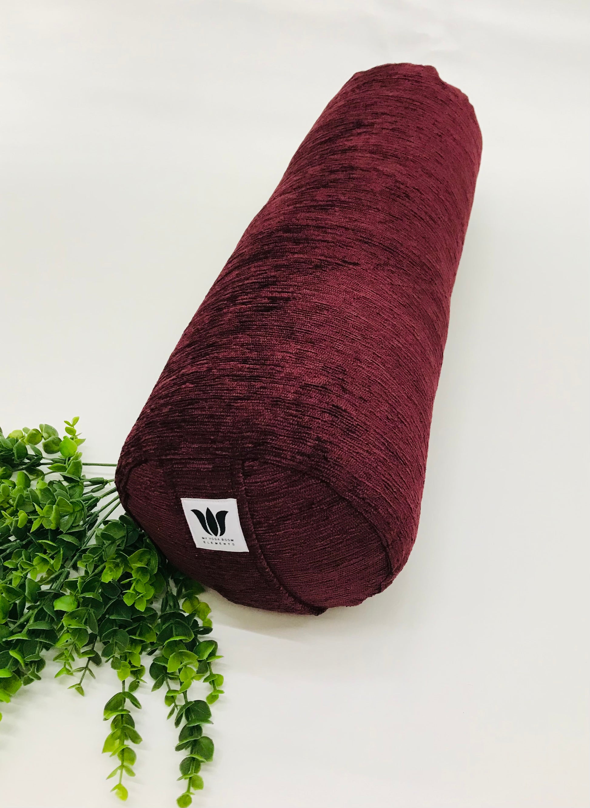 Round yoga bolster in durable plush, dark purple solid print fabric. Allergy conscious fill with removeable cover. Made in Canada by My Yoga Room Elements