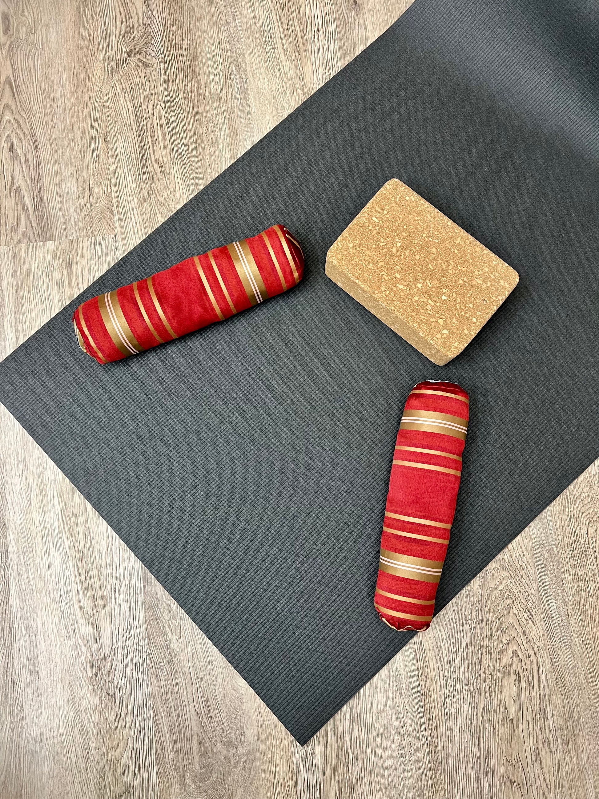 Mini yoga bolster in durable fabric, red gold stripe fabric. Cushion and support the body in the practice of yoga and meditation.Removeable cover. Made in Canada by My Yoga Room Elements