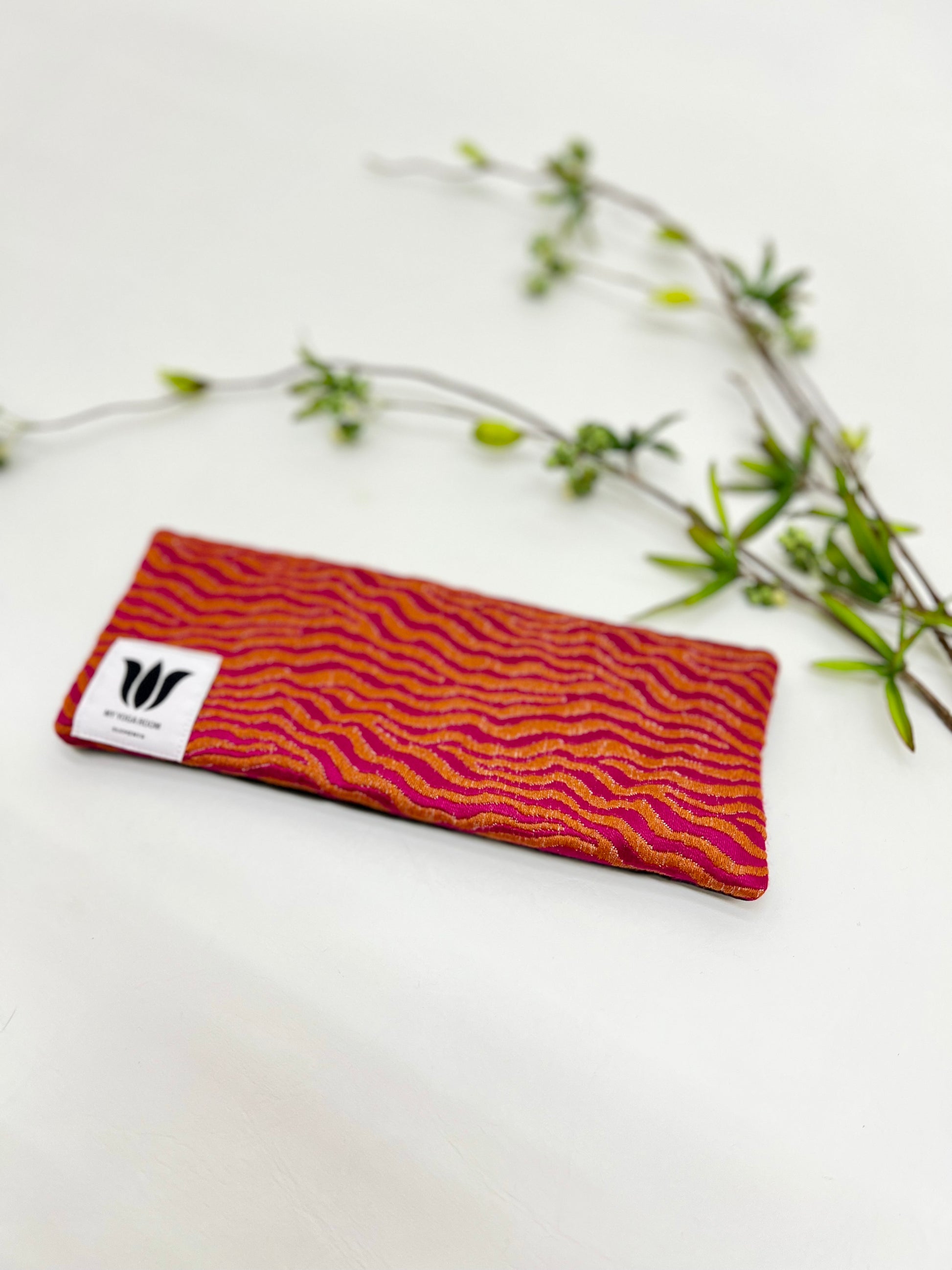 Yoga eye pillow, unscented, therapeutically weighted to soothe eye strain and stress or enhance your savasana. Handcrafted in Canada by My Yoga Room Elements. Orange/pink modern print and bamboo fabric.