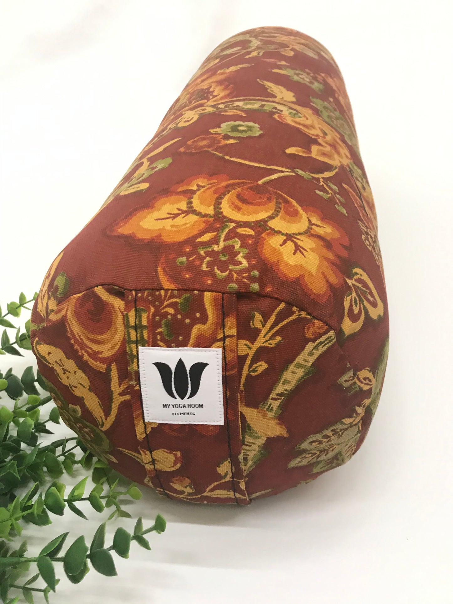 Round yoga bolster in cotton canvas burnt orange floral print fabric. Allergy conscious fill with removeable cover. Made in Canada by My Yoga Room Elements