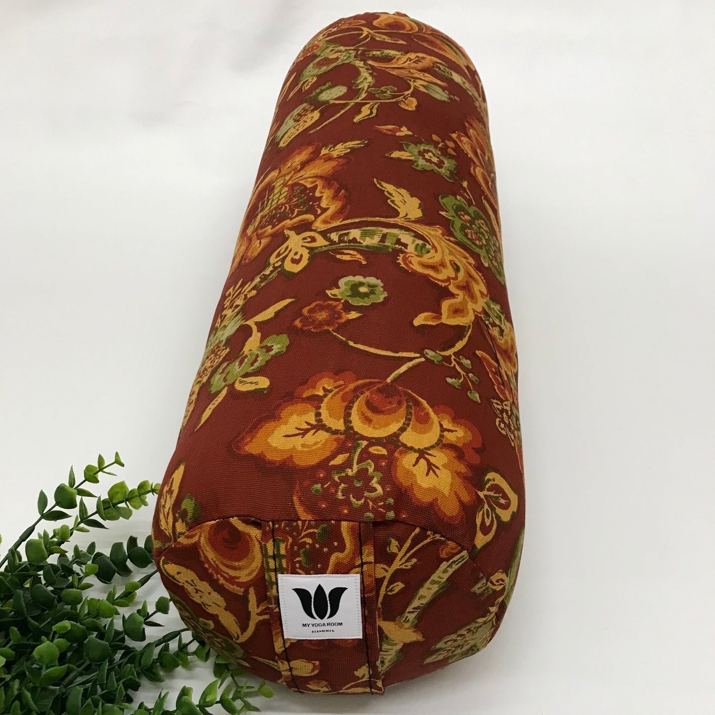 Round yoga bolster in cotton canvas burnt orange floral print fabric. Allergy conscious fill with removeable cover. Made in Canada by My Yoga Room Elements