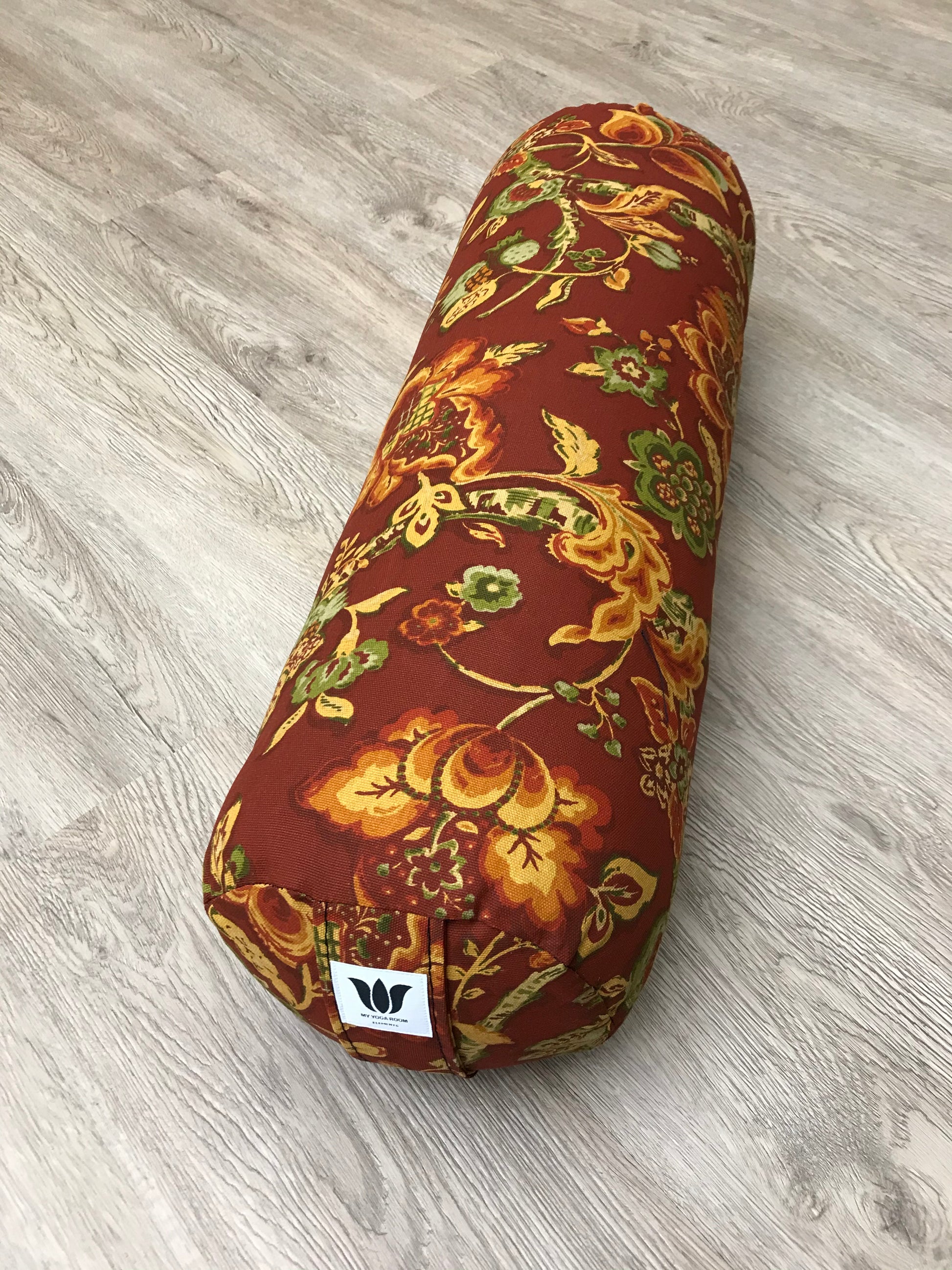 Round yoga bolster in cotton canvas burnt orange floral print fabric. Allergy conscious fill with removeable cover. Made in Canada by My Yoga Room Elements