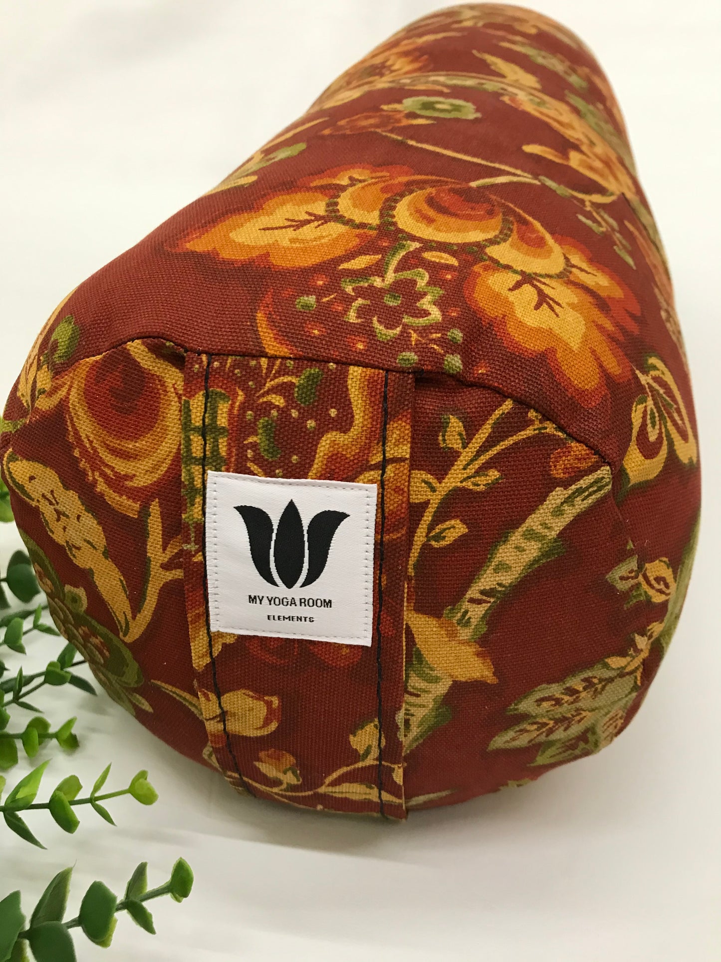 Round yoga bolster in cotton canvas burnt orange floral print fabric. Allergy conscious fill with removeable cover. Made in Canada by My Yoga Room Elements