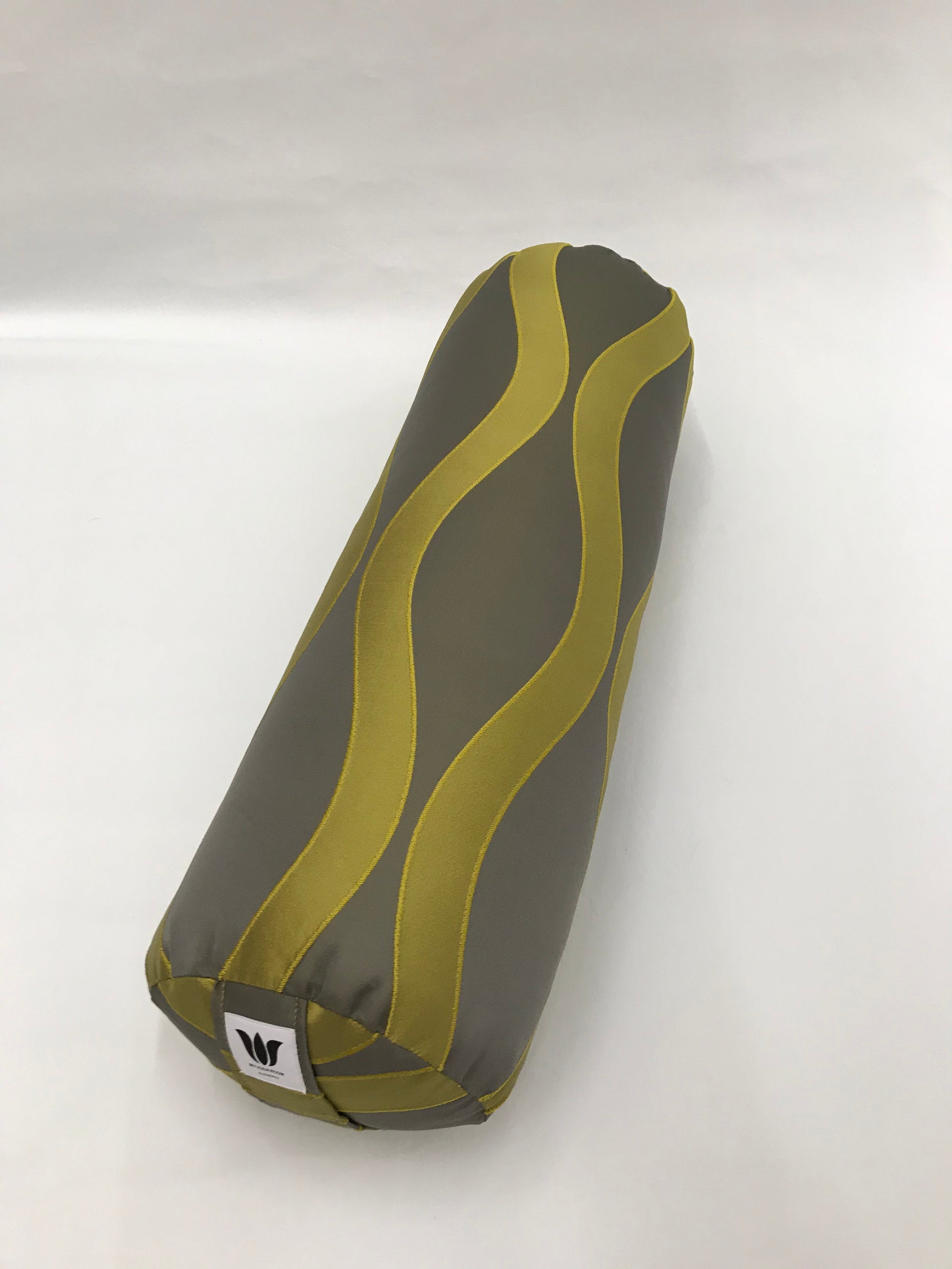 Round yoga bolster in modern graphic wave print, durable fabric, grey and green color fabric. Allergy conscious fill with removeable cover. Made in Canada by My Yoga Room Elements