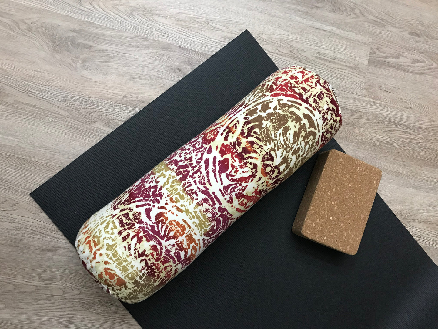 Round yoga bolster in durable cotton canvas, pink, yellow, orange, beige mottled print fabric. Allergy conscious fill with removeable cover. Made in Canada by My Yoga Room Elements