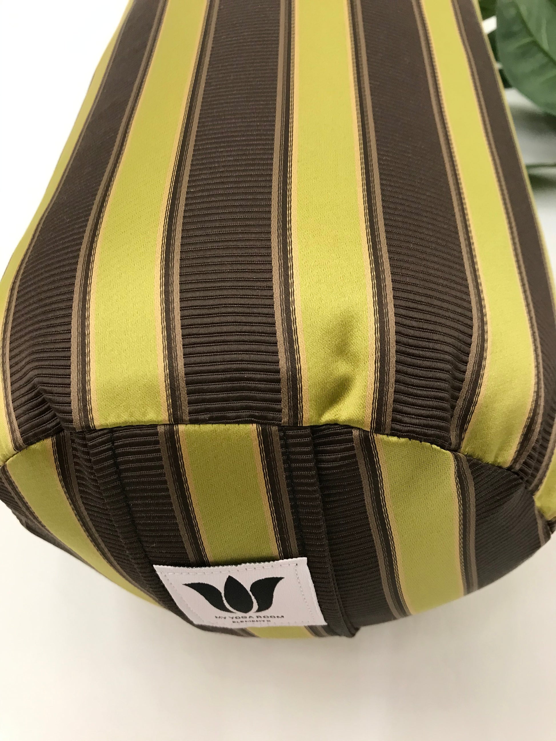 Round yoga bolster in durable sateen , eggplant coloured wide stripe fabric. Allergy conscious fill with removeable cover. Made in Canada by My Yoga Room Elements
