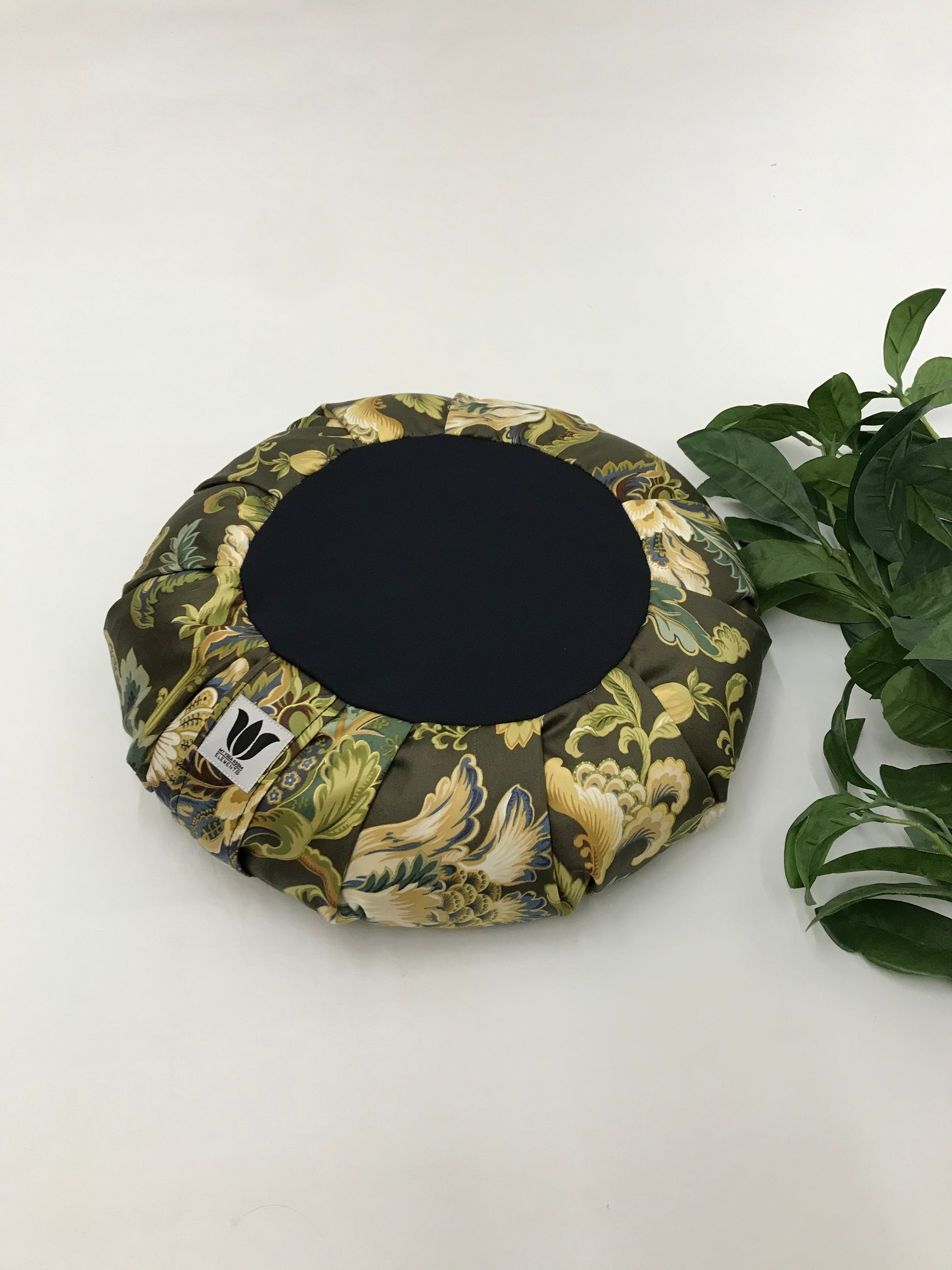 Handcrafted premium cotton sateen fabric meditation seat cushion in rich green and gold floral print fabric. Align the spine and body in comfort to calm the monkey mind in your meditation practice. Handcrafted in Calgary, Alberta Canada