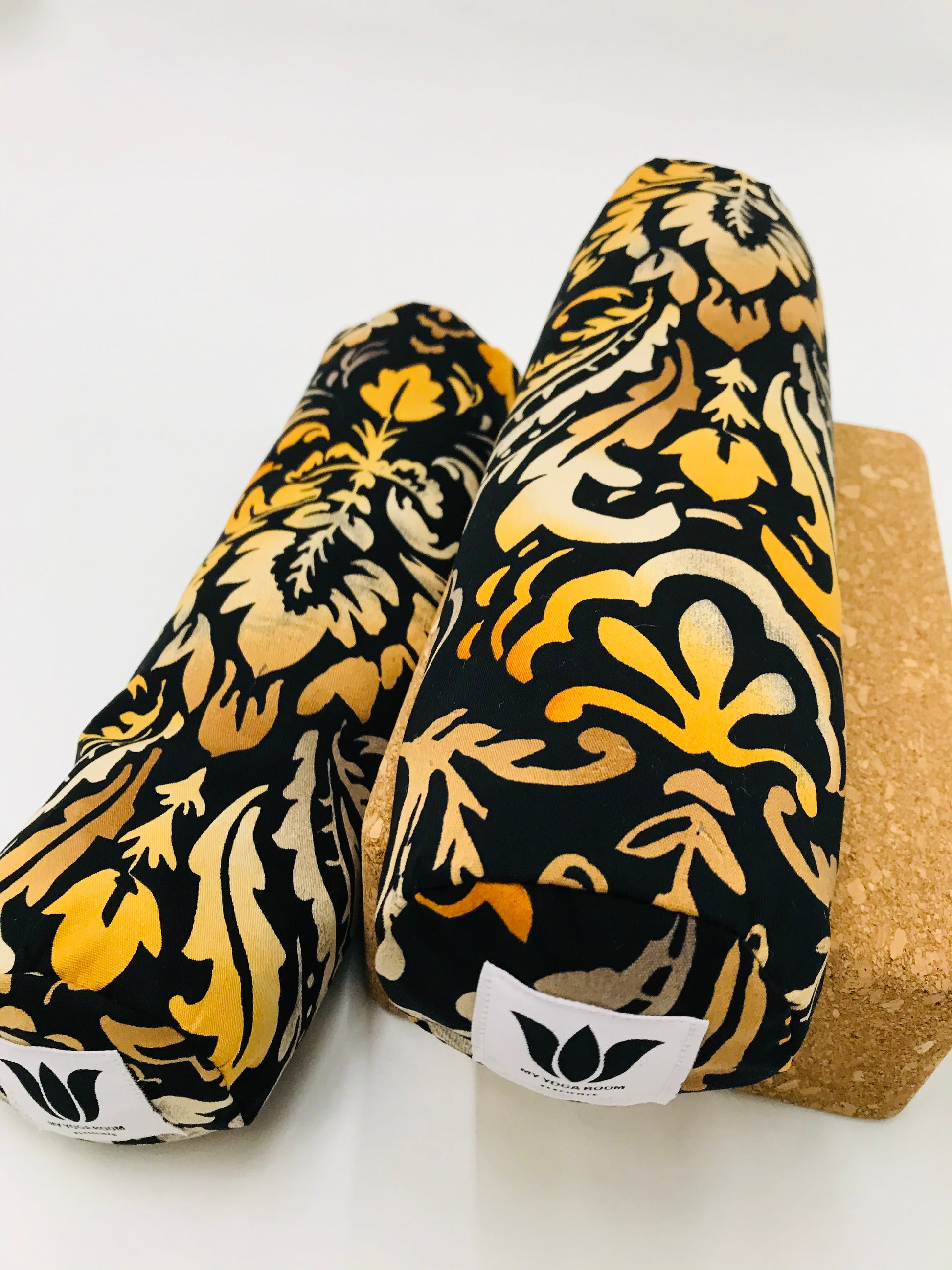 Mini yoga bolster in durable fabric, black and orange damask print fabric. Cushion and support the body in the practice of yoga and meditation.Removeable cover. Made in Canada by My Yoga Room Elements
