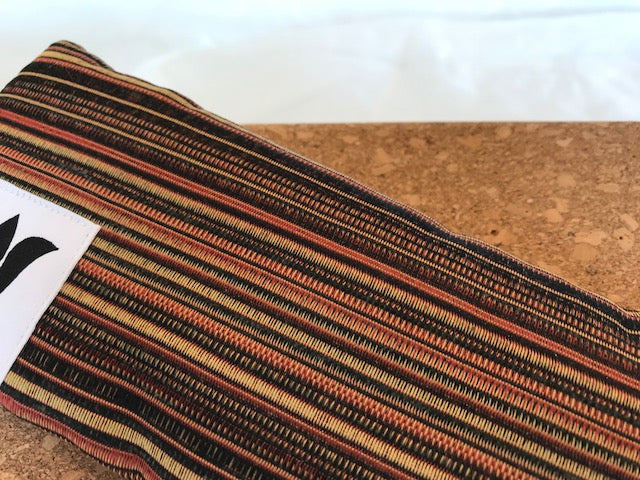 Yoga eye pillow, unscented, therapeutically weighted to soothe eye strain and stress or enhance your savasana. Handcrafted in Canada by My Yoga Room Elements. Pumpkin spice textured stripe print and bamboo fabric.