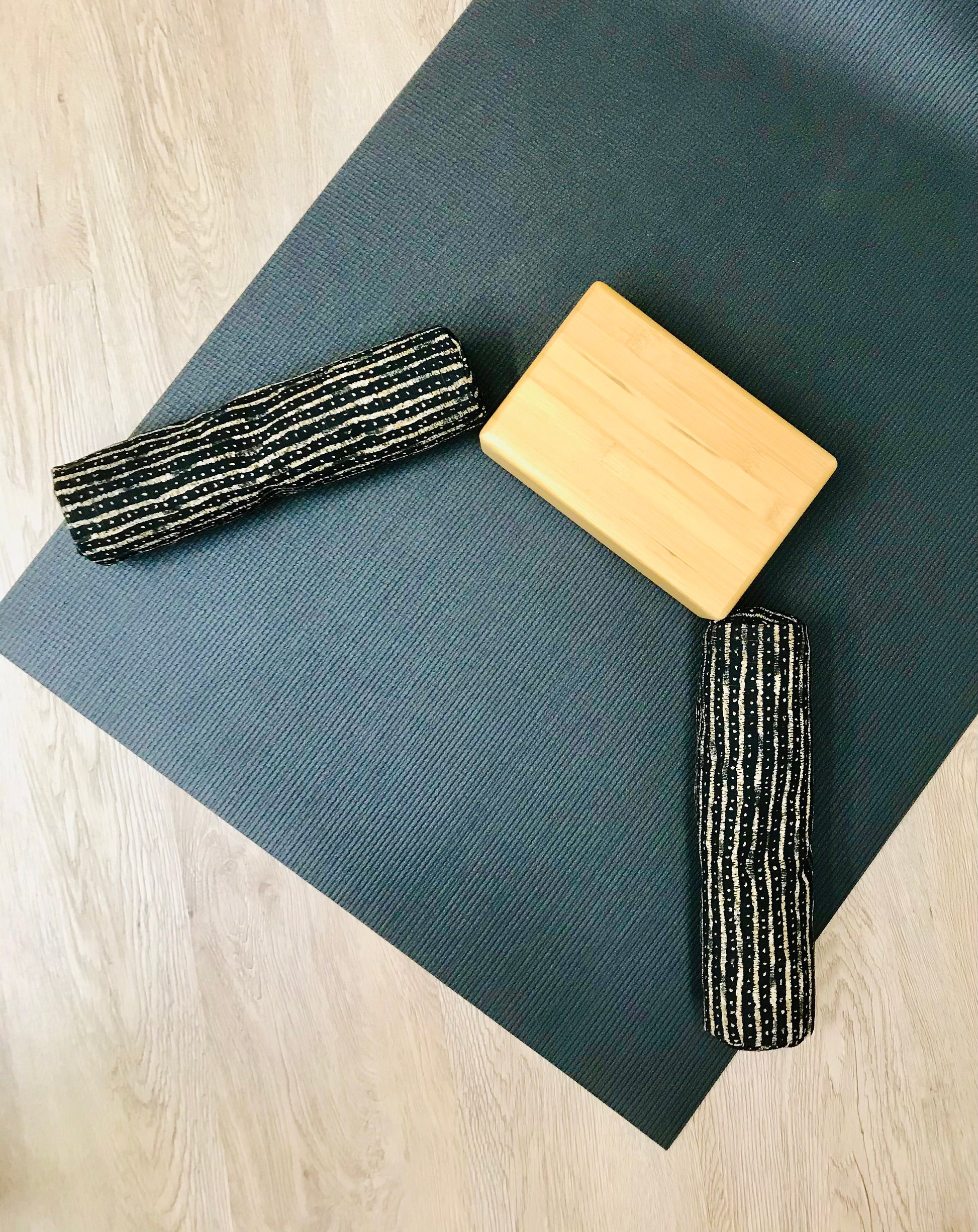 Mini yoga bolster in cotton canvas fabric, black and beige stripe fabric. Cushion and support the body in the practice of yoga and meditation.Removeable cover. Made in Canada by My Yoga Room Elements